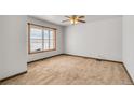Spacious carpeted bedroom with large window and ceiling fan at 14199 County Road 26, Fort Lupton, CO 80621