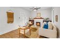 Bright living room with a fireplace, ceiling fan, and hardwood floors at 3002 Quitman St, Denver, CO 80212