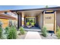 Inviting covered front porch with seating, modern brick, and stylish address display at 1830 S Fillmore St, Denver, CO 80210