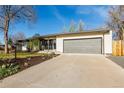 Ranch-style home with attached garage and concrete driveway at 6052 Taft St, Arvada, CO 80004