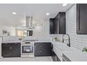 Modern kitchen with stainless steel appliances, white countertop, and subway tile backsplash at 6052 Taft St, Arvada, CO 80004