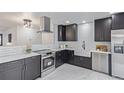 Modern kitchen featuring stainless steel appliances, white countertops, and subway tile backsplash at 6052 Taft St, Arvada, CO 80004
