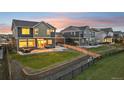 Lovely backyard featuring a patio area, green lawn, retaining wall and privacy fence at 16595 E 110Th Ave, Commerce City, CO 80022