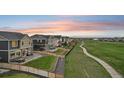 Expansive backyard with manicured lawn, patios, and views of the surrounding neighborhood at 16595 E 110Th Ave, Commerce City, CO 80022