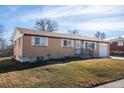 Side view of a single Gathering home featuring a traditional brick style and manicured lawn at 3288 W Tufts Ave, Englewood, CO 80110