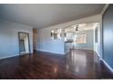 Spacious open-concept living room with hardwood floors seamlessly connecting to the kitchen at 3288 W Tufts Ave, Englewood, CO 80110
