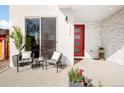 Inviting front porch with stone accent wall, seating area, and a vibrant red front door at 1333 Raleigh St, Denver, CO 80204