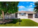 Well maintained lawn and landscaping leading up to this updated single-story home at 5554 Crystal Way, Denver, CO 80239