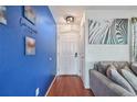 Inviting hallway with a vibrant blue accent wall and stylish zebra wall art at 19707 E Caspian Cir, Aurora, CO 80013