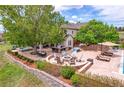 Beautifully landscaped backyard with built-in fire pit and outdoor seating at 7818 S Zeno St, Centennial, CO 80016