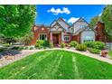 Charming home exterior with well-manicured lawn, stone accents, lush landscaping, and an inviting front entrance at 7818 S Zeno St, Centennial, CO 80016