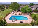 Amazing backyard pool with slide, basketball hoop, and lounge chairs at 7818 S Zeno St, Centennial, CO 80016