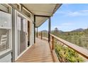 Covered deck with mountain views, modern railing, and sliding glass doors for indoor-outdoor living at 248 Copperdale Ln, Golden, CO 80403
