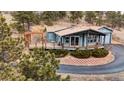 Charming home with large deck, manicured landscaping, and an inviting curb appeal in wooded neighborhood at 248 Copperdale Ln, Golden, CO 80403
