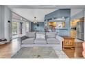Open living space with wood floors, access to a deck, and view to a kitchen with breakfast bar at 248 Copperdale Ln, Golden, CO 80403