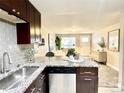 Kitchen open to the living room featuring a breakfast bar and stainless steel appliances at 4816 W 8Th Ave, Denver, CO 80204