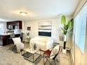 Open-concept living area with modern furniture, an adjacent kitchen, and natural light at 4816 W 8Th Ave, Denver, CO 80204