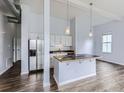 Modern kitchen features stainless steel appliances and a stylish breakfast bar with pendant lighting at 2501 15Th St # 3D, Denver, CO 80211