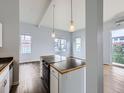 Cozy living area showcases a functional island and views through bright windows at 2501 15Th St # 3D, Denver, CO 80211