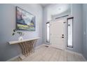 Bright entryway with a console table and large art piece at 6829 Juniper Ct, Frederick, CO 80530