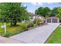 Beautiful home with an extra long driveway, detached garage, and well-manicured landscaping and garden at 1815 Ingalls St, Lakewood, CO 80214