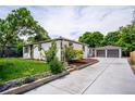 Beautiful home with a long driveway, detached garage, and well-manicured landscaping and garden at 1815 Ingalls St, Lakewood, CO 80214