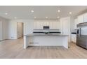 Modern kitchen with a large island, stainless steel appliances, and white cabinets at 2154 S Gold Bug Way, Aurora, CO 80018