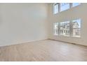 Bright living room featuring high ceilings, large windows, and light wood flooring at 2154 S Gold Bug Way, Aurora, CO 80018