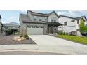 Two-story home with an attached garage and a concrete driveway at 3365 S Poppy St, Morrison, CO 80465