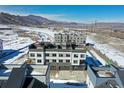 View of townhomes with attached garages and snow-covered mountain views at 14422 Pansy Loop, Morrison, CO 80465