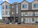 Townhome exterior with varied siding, brick accents, and covered entryways at 14422 Pansy Loop, Morrison, CO 80465