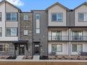 Stylish townhome with a contemporary design, a mix of siding materials, and small front yard space at 14422 Pansy Loop, Morrison, CO 80465