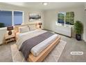 Serene bedroom featuring a comfortable bed, soft lighting, and large windows at 14822 E Adriatic Pl, Aurora, CO 80014