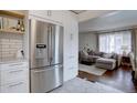Bright kitchen featuring stainless steel appliances and a view of the living room at 5191 S Logan St, Littleton, CO 80121