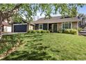Ranch style home with stone and siding and a large lawn at 17162 E Atlantic Pl, Aurora, CO 80013