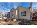 Tan house with a front porch and yard at 2600 S Downing St, Denver, CO 80210