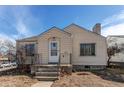 Tan house with a front porch and yard at 2600 S Downing St, Denver, CO 80210