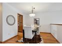 Bright dining room with hardwood floors and a modern chandelier creates an inviting space at 3079 E Long S Cir, Centennial, CO 80122