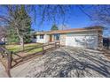 Spacious single-story home with a large driveway, attached garage, and well-kept front lawn at 1342 S Andes St, Aurora, CO 80017