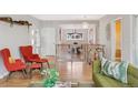Open-concept living area flows into the dining room, featuring hardwood floors and stylish furnishings at 260 S Jasmine St, Denver, CO 80224