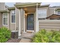 Welcoming entrance features a decorative door with porch cover, lush plants and walkway, and efficient air conditioning at 6839 Zenobia St # 3, Westminster, CO 80030