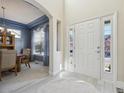 Bright foyer with light wood-look floors, a white front door and dining room views at 12453 Knox Ct, Broomfield, CO 80020