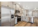 Well-equipped kitchen featuring stainless steel appliances and an adjacent dining area at 18338 E 93Rd Pl, Commerce City, CO 80022