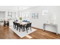 Bright dining area featuring hardwood floors, modern decor, and an open flow to the kitchen at 3884 Osceola St, Denver, CO 80212