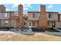 Charming townhome featuring a private entry, brick chimney, and well-kept front yard at 892 Summer Dr # 15B, Highlands Ranch, CO 80126