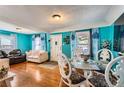 Bright living room with hardwood floors, colorful walls, and lots of natural light at 655 S Perry St, Denver, CO 80219