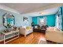 Inviting living room with hardwood floors, featuring a cozy seating arrangement and colorful decor at 655 S Perry St, Denver, CO 80219