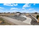 Aerial view of a home with a long driveway, a large lot, white fencing, and landscaping at 16197 Paris Way, Brighton, CO 80602