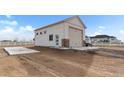 Detached garage with a roll-up door and side entry door for RV or boat storage at 16197 Paris Way, Brighton, CO 80602