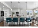 Bright kitchen features white cabinets, stainless appliances, granite countertops, and breakfast bar seating at 16197 Paris Way, Brighton, CO 80602